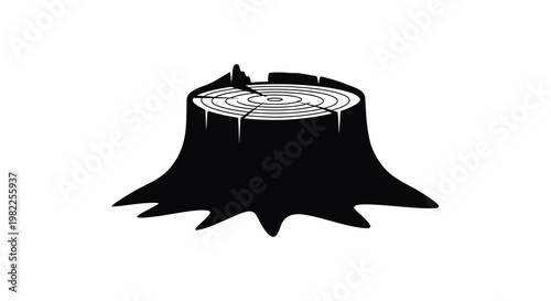 A stark black tree stump with annual rings a bold silhouette