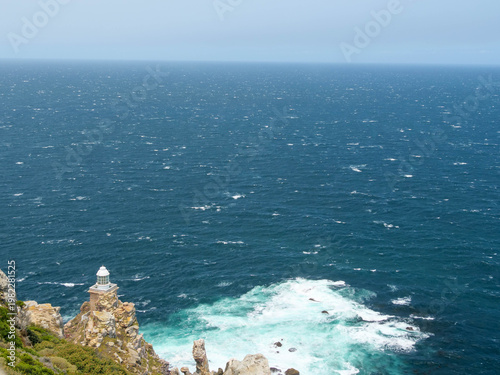 The new white lighthouse located on the edge or point at Cape Point, part of Table Mountain National Park, Cape Town, South Africa, a popular tourist and travel destination.