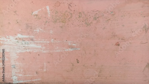 Peach painted wall texture with stains and peeling marks, perfect for soft backgrounds, pastel design, or vintage grunge themes