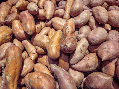 Sweet potatoes or yams in a tray in a farmers market