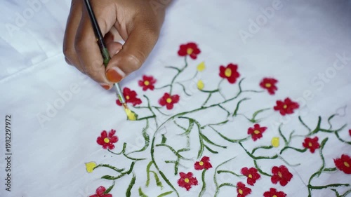 Young girl painting colorful floral patterns on white fabric for Pohela Boishakh festival, expressing child creativity, traditional Bengali culture, art education, and festive celebration. Drawing