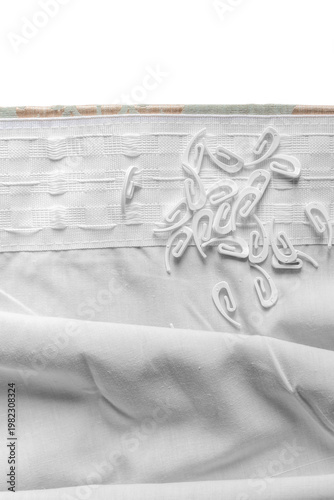 Plastic curtain hooks ont a curtain pleat preparing to hang curtains background backdrop.