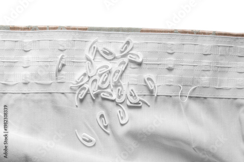 Plastic curtain hooks ont a curtain pleat preparing to hang curtains background backdrop.