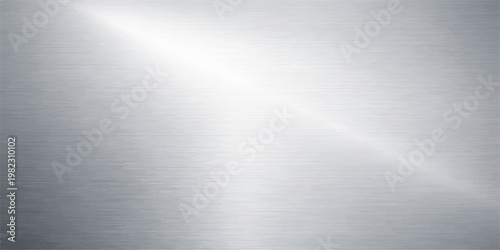 A polished silver brushed metal plate background features a shiny stainless steel texture with a smooth metallic grey surface and light reflections on an aluminum backdrop pattern