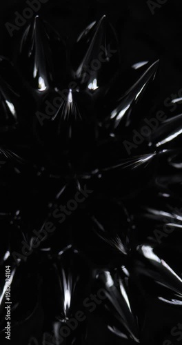 Vertical video background, magnetic substance. Magnetic fluid. Ferrofluid. Black liquid surface. Abstract background.