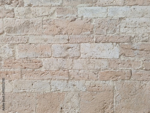 Tablou pe pânză Detail of a building wall covered with Sellano sponga stone, a type of local travertine, an extremely porous and light calcareous sedimentary rock, reminiscent of a sponge in appearance