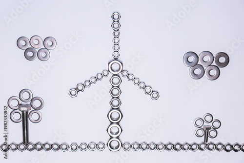 A creative composition with metal pieces (nuts, washers, and bolts) forming a wind turbine in the center, accompanied by flower-like figures on the sides. The lower line, made with nuts, 