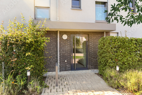 View to entrance door of a modern residential building with new apartments in the city