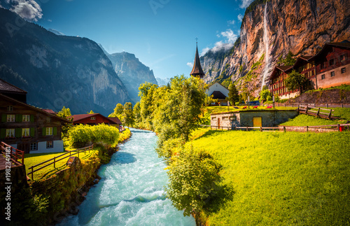 Charming alpine village in the Lauterbrunnen valley on a sunny day. Location place Bernese Alps, Switzerland, Europe.