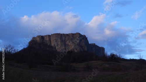 Time lapse video of the Pietra of Bismantova at sunset with a cloudy sky. Castelnuovo Monti, Reggio Emilia, Italy