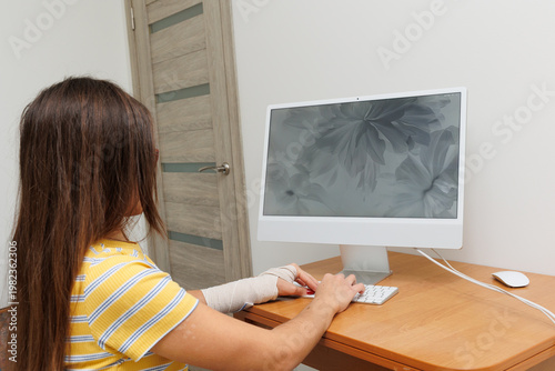 Woman working on computer at home desk
