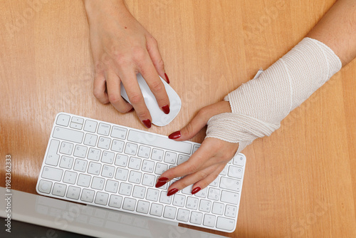 Woman working on computer at home desk