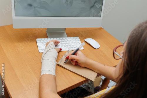 Woman working on computer at home desk