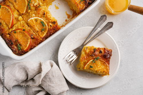 traditional greek orange pie on the plate - Portokalopita with thyme, top view