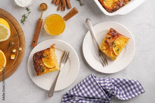 traditional greek orange pie on two plates - Portokalopita with thyme, top view