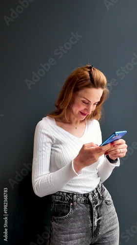 Smiling woman texting on smartphone enjoying digital communication