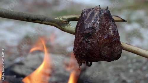 Roast cooking over open camp fire