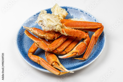 Cooked snow crab leg clusters on a dinner plate isolated on white