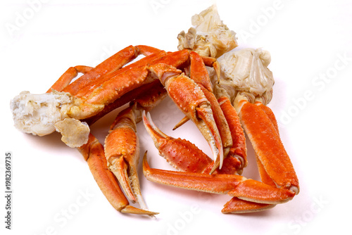 Cooked snow crab clusters showing teh claws in a pile isolated on white