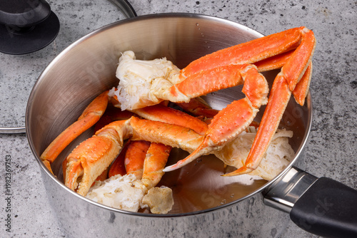 Cooked snow crab clusters showing the claws in a shivey cooking pot to be steamed