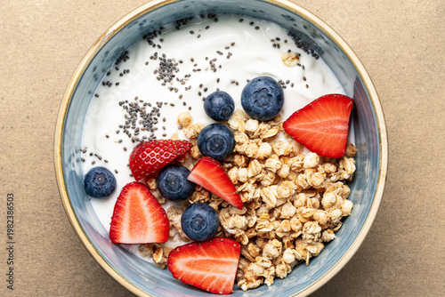 Healthy breakfast with granola yogurt fresh berries and chia seeds top view