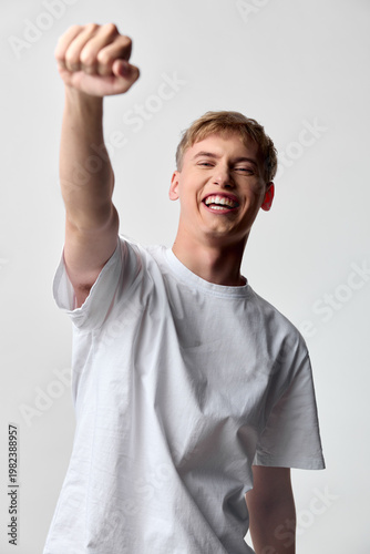 Obraz na plátně Victory, celebration, and confidence as a cheerful man raises his fist in a casu
