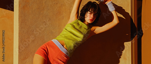 Creative dance pose in warm sunlight with bold fashion and playful expression