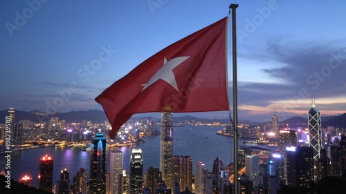 Hong Kong Skyline with Red Star Flag Waving at Dusk