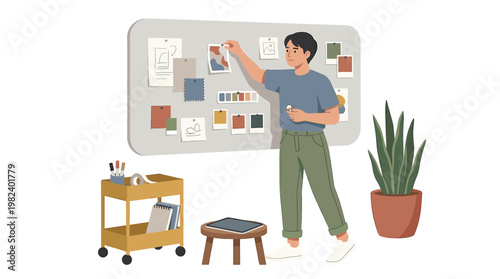 Male designer pinning sketches and color palettes to a mood board