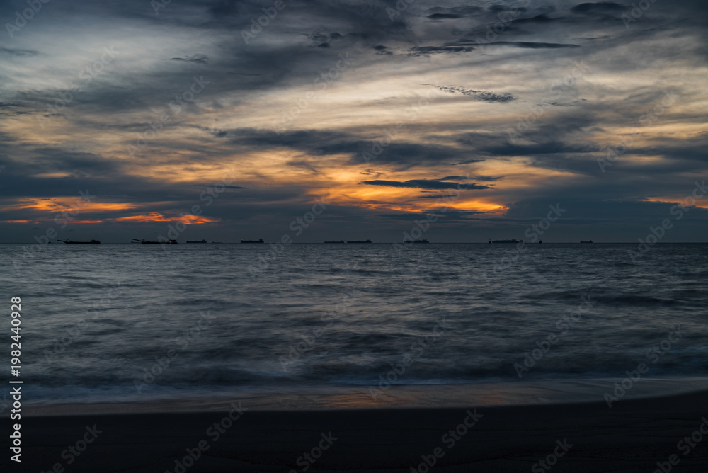 Obraz premium blue hour seascape over Melaka or Malacca Straits coastal beach and sea at Pantai Puteri