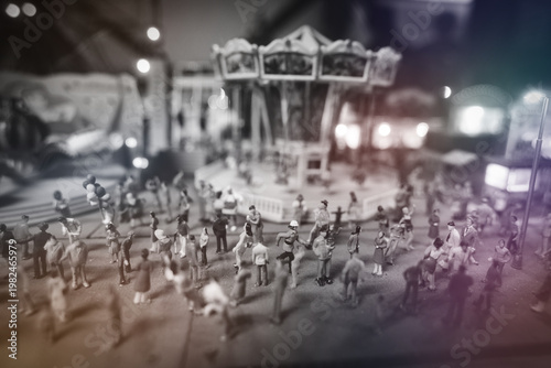 Dancing crowd of dolls in front of the carousel