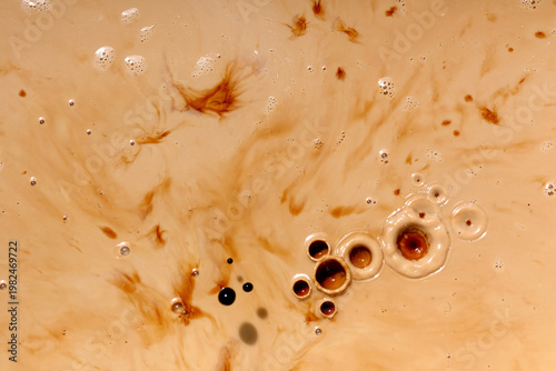Top view of black coffee splash on milk