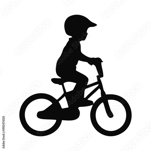 silhouette of a child riding a BMX bike with head protection and elbow protectors