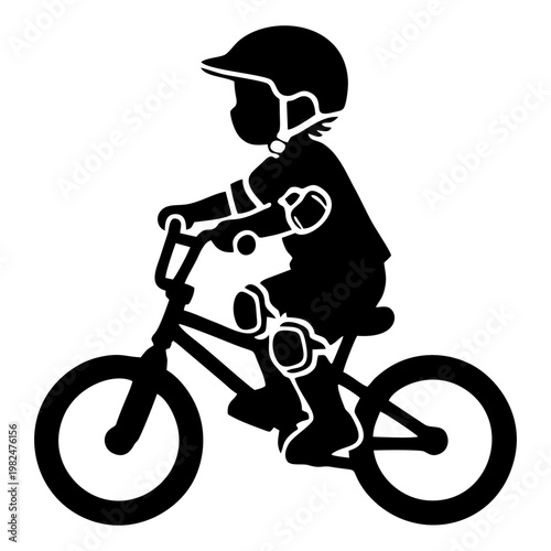 silhouette of a child riding a BMX bike with head protection and elbow protectors