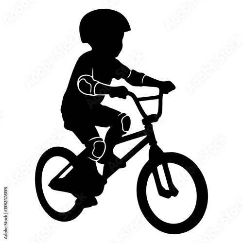 silhouette of a child riding a BMX bike with head protection and elbow protectors