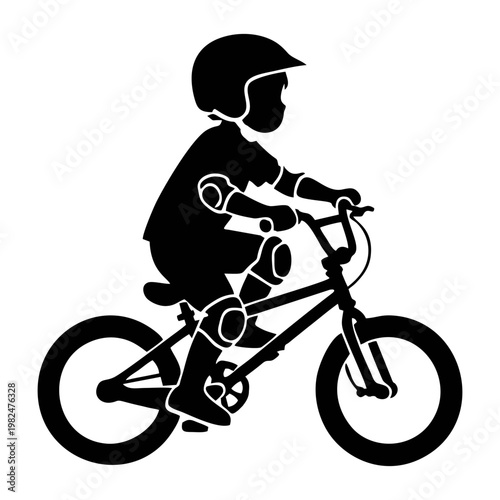 silhouette of a child riding a BMX bike with head protection and elbow protectors