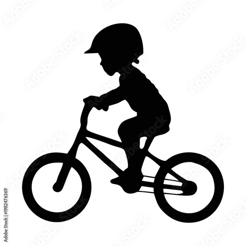 silhouette of a child riding a BMX bike with head protection and elbow protectors