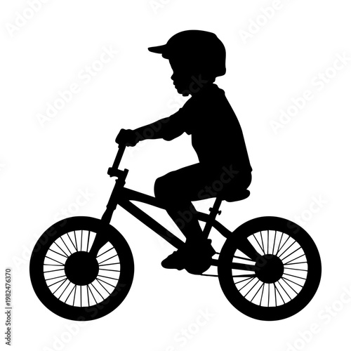silhouette of a child riding a BMX bike with head protection and elbow protectors