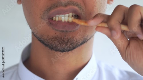 Man using miswak for traditional oral hygiene