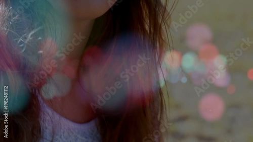 Camera rising and focusing up, female teen holding acoustic guitar smiling, revealing lace headband