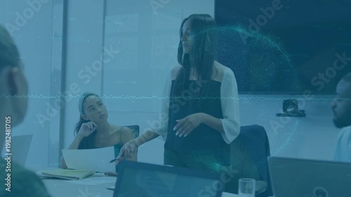 Standing speaker tapping pen, presenting, informing team in business, animated charts on monitor