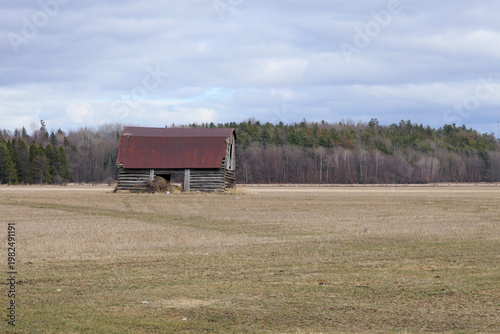 An old wooden barn in a field