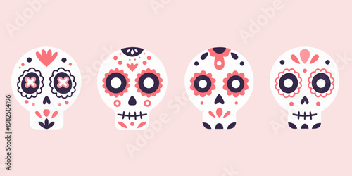 Four colorful sugar skulls arranged on a pale pink background