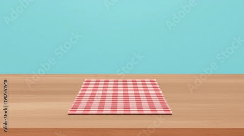 Empty wooden deck table and red checked tablecloth over mint wallpaper background