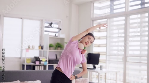 Asian adult woman stretch exercise home living room promoting fitness wellness flexibility healthy lifestyle active morning routine