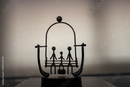 Metal Kinetic Balance Toy of a Family on a Swing - Perpetual Motion Desk Ornament