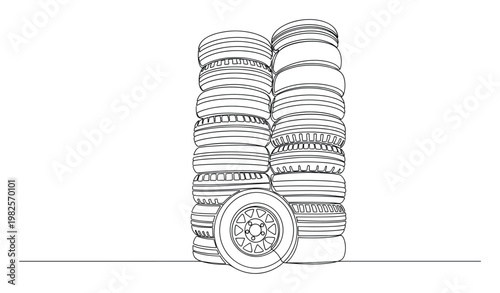 Automotive garage service and repair business concept with neatly stacked car tires and a single wheel for vehicle maintenance and spare parts inventory showcase
