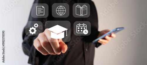 Hand taps digital icons representing education and technology. Professional tone suggests innovation in learning and development.