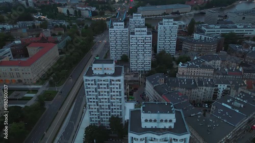 Aerial view of apartment towers streets and riverside district at dusk in Wroclaw Poland. Concept of urban housing city infrastructure and modern residential architecture