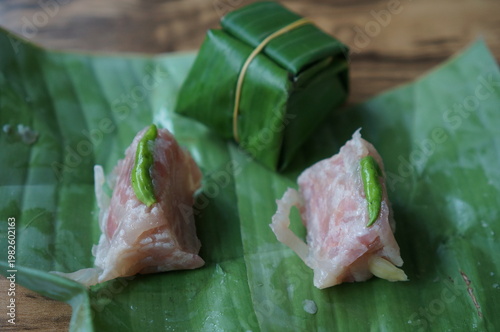 Authentic Thai Naem Moo or fermented pork sausage wrapped in banana leaf